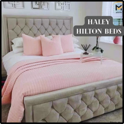 A bed with a tufted headboard and light pink bedding.