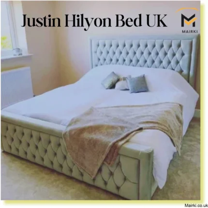 A luxurious Justin Hilyon bed with a light gray headboard and footboard in a serene bedroom.