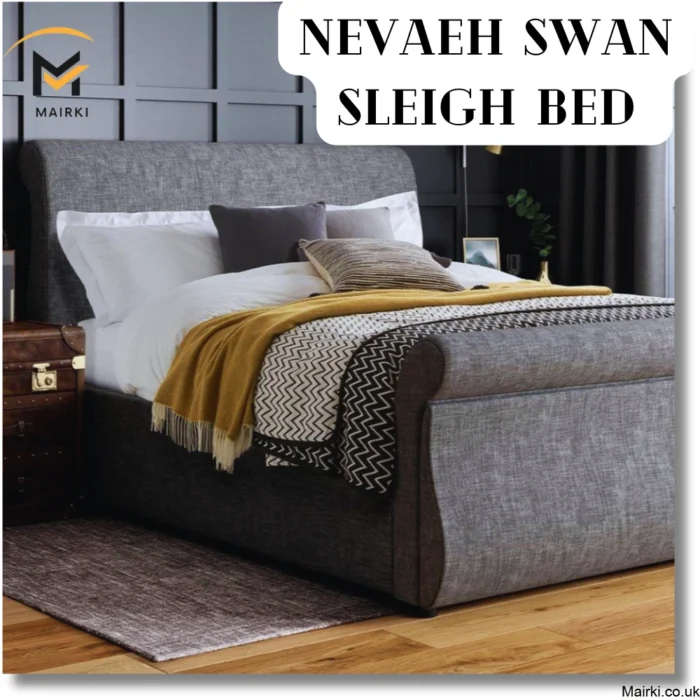 Nevaeh Swan upholstered gray sleigh bed with layered bedding and vintage trunk at the bedside.