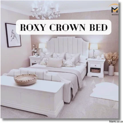 A modern bedroom featuring the "Roxy Crown Bed" with a tufted headboard, surrounded by elegant furnishings in neutral tones.