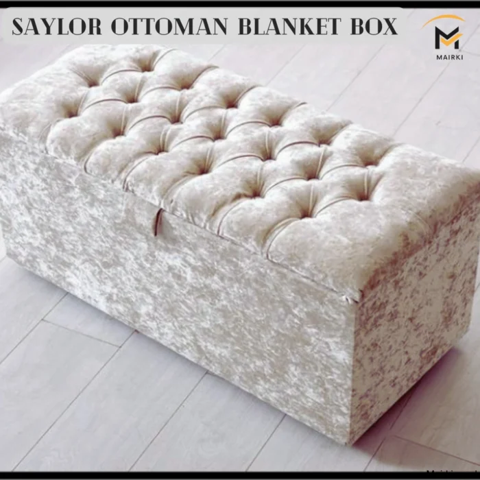 Saylor Ottoman Blanket Box with tufted cream fabric on a light wood floor.