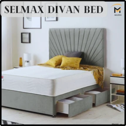 Grey divan bed with a tufted headboard, yellow pillows, and pull-out storage drawers.