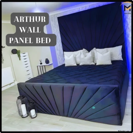 A bedroom with a dark panel bed and geometric headboard, white pillows, and ambient blue lighting.