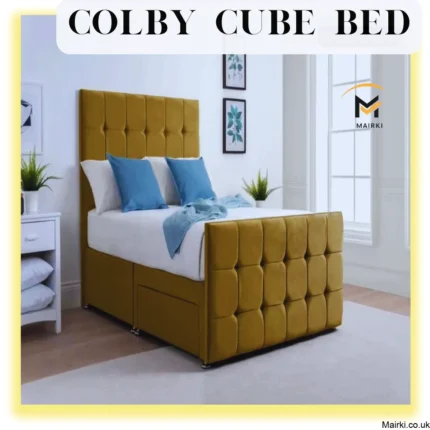 Mustard-yellow tufted bed with storage, white and blue bedding, in a bright room.