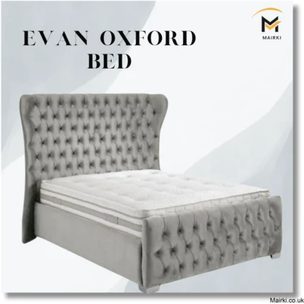 Gray tufted bed with high headboard.