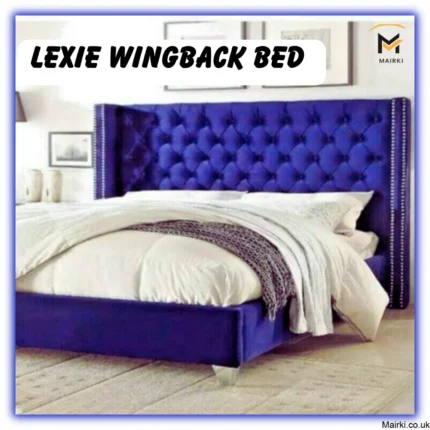 Blue tufted Lexie Wingback Bed with white bedding in a minimalist room.