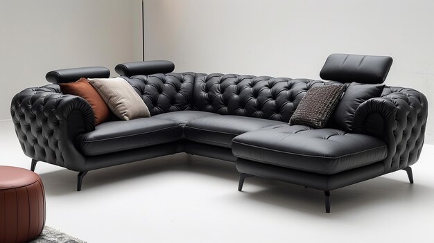 A large, black leather Corner sofa with a tufted design, throw pillows, and metal legs. The sofa is in a modern living room.