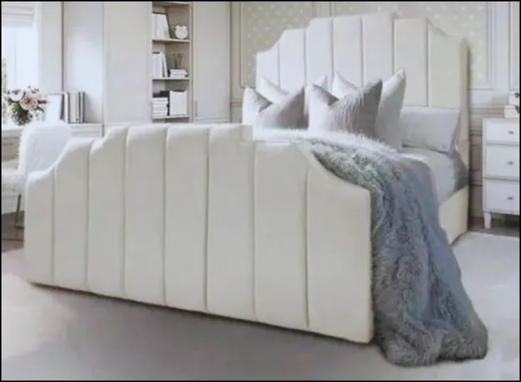 Luxurious bedroom with a king-size bed featuring cream upholstered headboard and footboard.