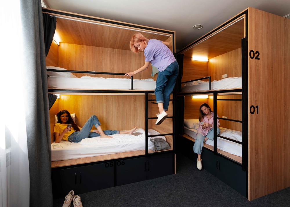 Compact room with space saving beds with integrated lights and numbered storage cabinets.