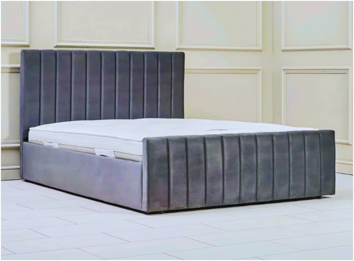 Super king size bed with tufted gray headboard and footboard.