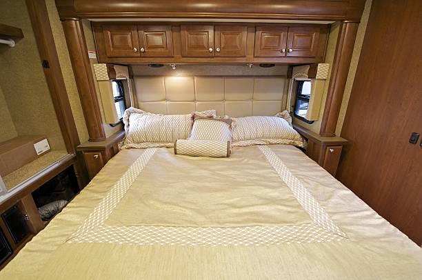 Bedroom with a large bed and overbed storage cabinets.