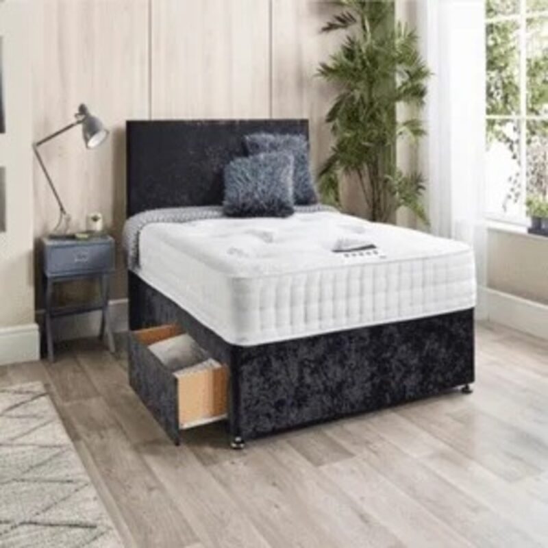 A bed with a crush velvet bed base and headboard in a modern bedroom setting.